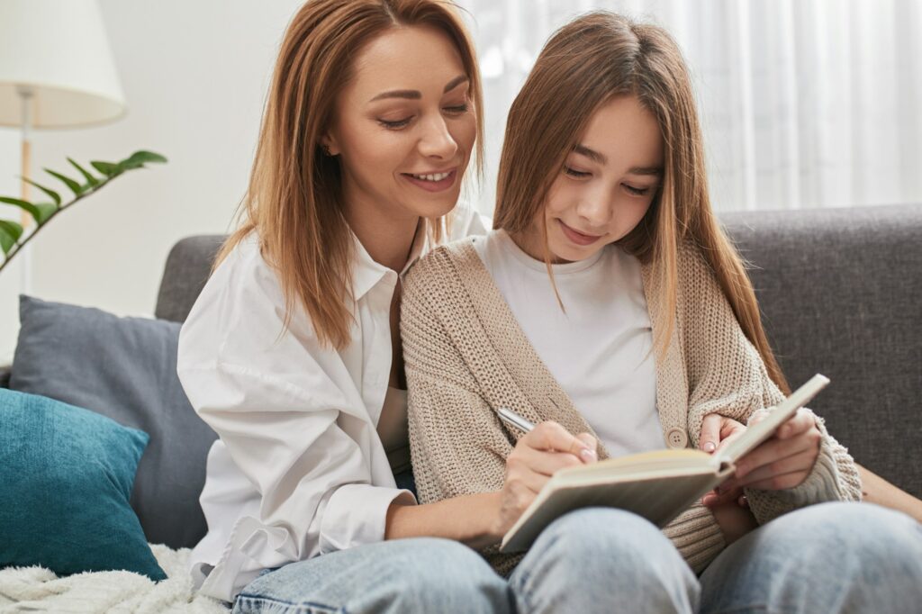 Mother helping daughter with homework